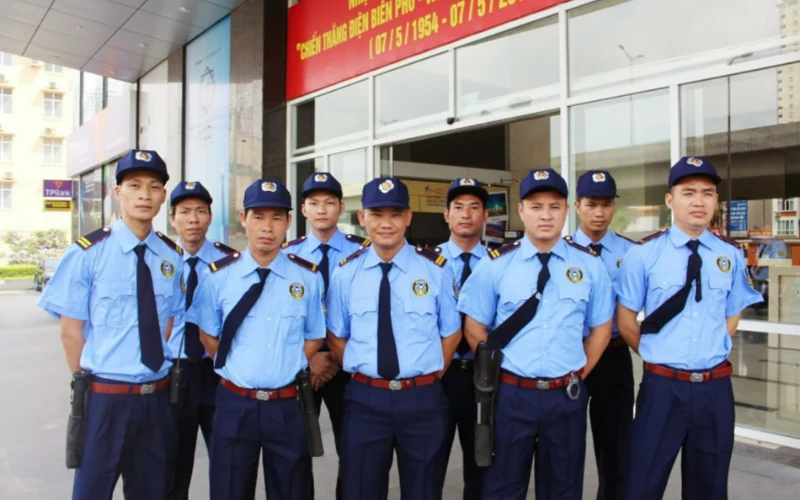 Đội ngũ bảo vệ Long Việt Đội ngũ bảo vệ Long Việt mặc đồng phục xanh trước văn phòng